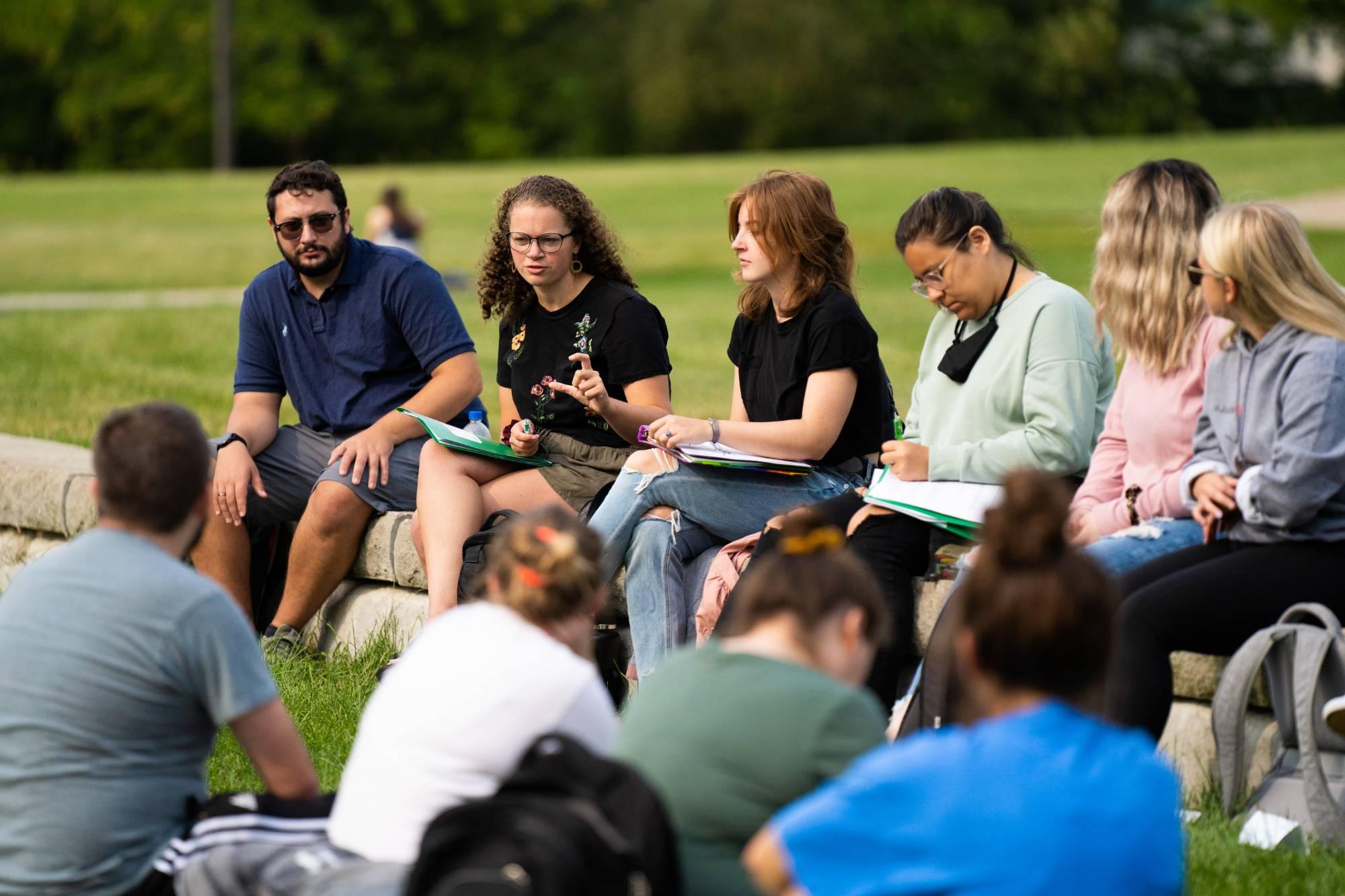 Group of students sitting outside during class